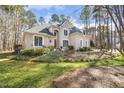 Spacious property with manicured lawn and mature trees surrounding the elegant home at 7420 Heartland Dr, Wake Forest, NC 27587