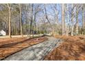 Scenic view of a gravel path leading through a wooded area at 7420 Heartland Dr, Wake Forest, NC 27587