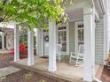 Quaint front porch with rocking chairs, offering a comfortable and inviting space to enjoy the outdoors at 7829 Acc Blvd, Raleigh, NC 27617