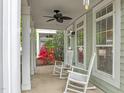 Relax on this covered front porch complete with rocking chairs and lush landscaping at 7829 Acc Blvd, Raleigh, NC 27617