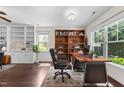 Bright office space featuring dark hardwood floors, built-in bookshelves, and natural light at 7851 Allscott Way, Raleigh, NC 27612