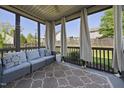 Relaxing screened porch with comfortable seating and a view of the backyard at 1010 Smoke Willow Way, Rolesville, NC 27571