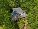 Aerial view of a beautiful house with lush landscaping and mature trees providing privacy and a serene setting at 102 Treadwell Ct, Cary, NC 27513