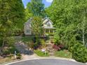 Two-story home with charming curb appeal, lush landscaping, a welcoming front porch and an inviting walkway at 102 Treadwell Ct, Cary, NC 27513