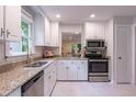 Bright and spacious kitchen with stainless steel appliances and light granite countertops at 104 Silver Fox Ct, Cary, NC 27511