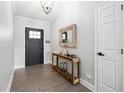 Welcoming entryway with wood floors, console table, modern mirror, and neutral paint at 1202 Lexington Ridge Ln, Apex, NC 27502
