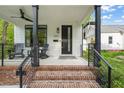 Inviting front porch with brick steps and black metal railings at 1202 S Bloodworth St, Raleigh, NC 27601
