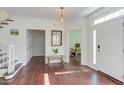Bright foyer with dark wood floors, white trim, and staircase to the left at 1311 Antler Point Dr, Durham, NC 27713
