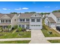 Aerial view of a two-story home, showcasing the surrounding neighborhood and meticulously maintained landscaping at 1410 Arena Ln, Fuquay Varina, NC 27526