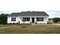 Charming single-story home with white siding and a well-manicured lawn on a cloudy day at 146 Starry Sky Dr, Benson, NC 27504