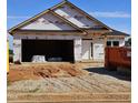 Unfinished new home featuring a two-car garage and white front door at 16 Decatur Dr, Fuquay Varina, NC 27526