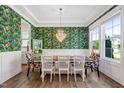 Elegant dining room with tray ceiling, stylish wallpaper, and ample natural light at 1711 Sandoval Dr, Durham, NC 27703