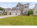 Beautiful two-story home with a spacious front lawn and three-car garage at 1711 Sandoval Dr, Durham, NC 27703