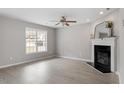 Bright living room with large windows and a decorative fireplace at 197 Scranton Ct, Cameron, NC 28326