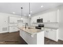 Modern kitchen with white cabinets, granite countertops, and stainless steel appliances at 200 Pretty Run Branch Ln, Wendell, NC 27591
