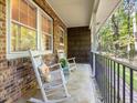 Inviting porch with classic rocking chairs, perfect for enjoying the wooded surroundings at 203 Wood Cir, Chapel Hill, NC 27514
