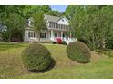 Inviting two-story home with a covered front porch and a well-manicured lawn at 204 Black Forest Dr, Clayton, NC 27527
