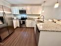 Updated kitchen featuring stainless appliances, granite counters, and wood floors at 2101 S Roxboro St, Durham, NC 27707