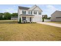 A well-maintained two-story home with classic architectural features and a spacious yard at 214 Thumper Way, Clayton, NC 27520