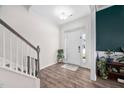 Bright foyer with hardwood floors, staircase, and views into other living spaces at 214 Thumper Way, Clayton, NC 27520