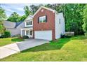 View of a two-story home with a lush lawn, showcasing its suburban setting at 217 Carolina Town Ln, Holly Springs, NC 27540