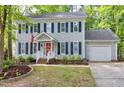 Two-story home featuring gray siding, dark shutters, and a welcoming front porch with brick steps at 2205 Long And Winding Rd, Raleigh, NC 27603