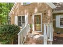 Close-up of a charming brick home entrance with a decorative glass front door at 224 Heidinger Dr, Cary, NC 27511