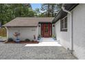 Inviting front entry with a vibrant red door and potted plants at 226 Smith Dr, Durham, NC 27712