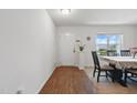 Inviting dining area with wood floors, neutral carpet, and a view to the home's front yard at 227 Sumter Ct, Burlington, NC 27217