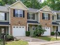 Inviting townhouse with brick accents, verdant landscaping, and convenient single-car garage in a peaceful setting at 23 Great View Ct, Clayton, NC 27527