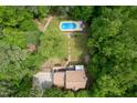 An aerial view of a home with a backyard featuring a swimming pool and lush landscaping for outdoor enjoyment at 2312 Laurelford Ln, Wake Forest, NC 27587