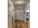 Inviting entryway featuring hardwood floors, a front door with decorative window, and arched doorway at 2528 Beech Gap Ct, Raleigh, NC 27603