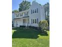 Traditional two-story home featuring blue shutters, an attached garage, and a green lawn at 2528 Beech Gap Ct, Raleigh, NC 27603