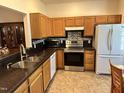 Well-equipped kitchen with stainless steel appliances, oak cabinets, and granite countertops at 2528 Beech Gap Ct, Raleigh, NC 27603