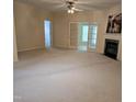 Spacious living room featuring a fireplace, ceiling fan, and lots of natural light at 2565 Bent Green St, Raleigh, NC 27614