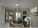 Open-concept living room features a chandelier, fireplace, and access to outdoor space at 2565 Bent Green St, Raleigh, NC 27614