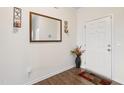 Bright entryway features wood-look floors, a decorative mirror, and a charming vase of flowers adding a touch of elegance at 270 Oak Park Blvd, Youngsville, NC 27596