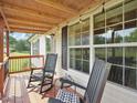 Comfortable front porch with chairs, perfect for relaxing and enjoying the view with string lights at 2705 Flat Rock Rd, Franklinton, NC 27525
