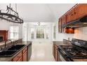View of kitchen showing granite counters, lots of cabinet space, and eat-in breakfast nook at 300 Ravenstone Dr, Cary, NC 27518