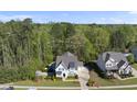 Aerial view of a home with a backyard pool, lush greenery, and neighborhood landscape at 3138 Curling Creek Dr, Apex, NC 27502