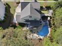Aerial view of a backyard featuring a pool, outdoor seating, and a meticulously maintained lawn at 3138 Curling Creek Dr, Apex, NC 27502