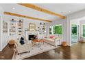Cozy living room with fireplace, built-in shelving, hardwood floors, and an abundance of natural light at 3312 Rock Creek Dr, Raleigh, NC 27609
