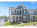 Charming two-story home with a welcoming front porch and manicured landscaping at 361 Natsam Woods Way, Wake Forest, NC 27587