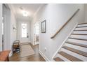 Bright foyer with hardwood floors, staircase, and ample natural light at 361 Natsam Woods Way, Wake Forest, NC 27587
