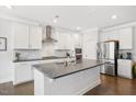 Modern kitchen featuring stainless steel appliances, large island, and white cabinetry at 361 Natsam Woods Way, Wake Forest, NC 27587