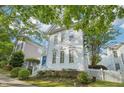 Charming two-story home with white siding, a blue front door, and a lovely tree-lined street at 403 Brookgreen Dr, Chapel Hill, NC 27516