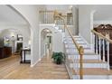 Elegant foyer with a staircase, hardwood floors, and neutral wall paint providing a bright and inviting atmosphere at 408 Evert Dr, Cary, NC 27511