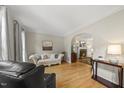 Cozy living room with hardwood floors, a decorative fireplace, and comfortable seating arrangement at 408 Evert Dr, Cary, NC 27511