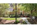 Brick home with mature trees, a walkway to the front door, and a lush, green lawn at 4101 John S Raboteau Wynd, Raleigh, NC 27612