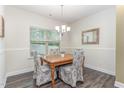 Cozy dining room with wood table, decorative chairs, chandelier, and natural light at 49 Parkside Dr, Lillington, NC 27546